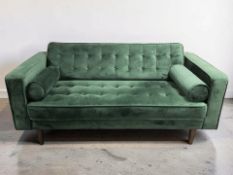 A modern two seater settee in dark green upholstery with bolster cushions, length 170 cm.