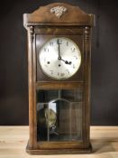 An early 20th century beech eight day wall clock, height 82 cm.