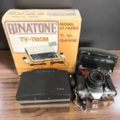 A Praktica MTL3 camera, a further Polaroid 355 camera and a Binatone TV-Tron game in box.