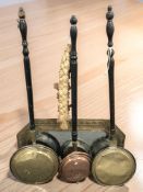 An embossed brass octagonal mirror and three various bed warming pans.