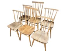 A set of four Ercol elm and beech model 391 spindle back dining chairs,