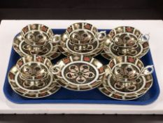 Five Royal Crown Derby imari porcelain tea cup, saucer and tea plate trios, pattern 1128,