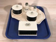 A group of Art Deco pink plastic dressing table items.