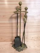 A Victorian cast brass and steel fire companion set.