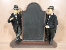 A Laurel & Hardy themed chalk board, height 82 cm.