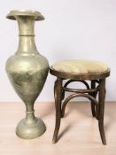A large engraved brass vase, height 80 cm, and a bentwood stool.