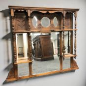 A late Victorian carved walnut over mantel mirror, 108 cm W x 93 cm H.