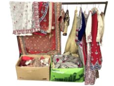 A collection of decorative sequined dresses and waist coats, shawls and other similar clothing.