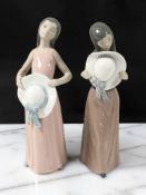 Two Lladro figures of girls holding summer hats, No. 5008 and 5007.