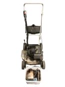 A Victa petrol mower and a box containing parts and hardware.