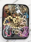 A tray of costume jewellery, beaded necklaces, identity bracelet, etc.