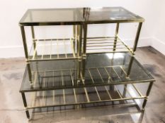 Three brass and smoked glass coffee / lamp tables, the largest 123 cm long.