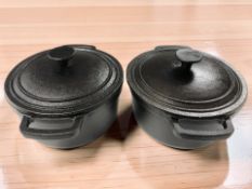 A pair of cast iron twin handled cooking pans, diameter 20 cm excluding handles.