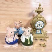 A late 19th century French gilt metal mantel clock (a/f), and three Wade Natwest pigs.