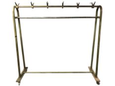 A large metal clothes rail on trolley castors, length 185 cm.