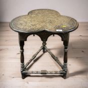 An Arts & Crafts carved oak trefoil table, height 68 cm.