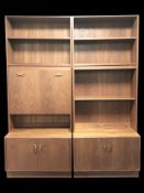 A 20th century G-Plan teak two section open bookcase incorporating a cocktail cabinet and double
