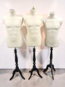 Three 20th century mannequins on tripod stands.