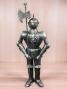 A reproduction metal statue of a knight with halberd, height 140 cm.