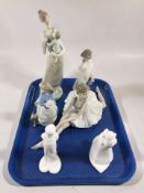 A Lladro figure of a mother with child, three Nao figures and two Royal Doulton Images figures.