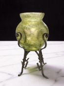 A Loetz iridescent glass dimpled vase on metal stand,