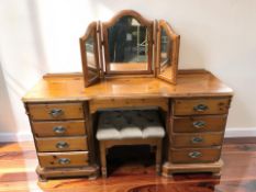 A 20th century pine dressing table with mirror back and a stool, 156 cm x 47 cm x 131 cm.