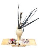A sewing box and a pottery vase containing artificial flowers.