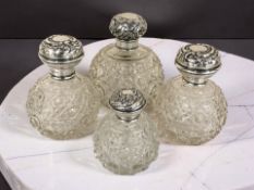 Four silver mounted crystal dressing table jars, tallest 11 cm.