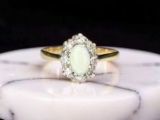 An opal and diamond cluster ring, stamped 18ct, size N CONDITION REPORT: 2.
