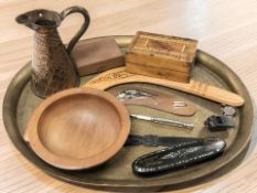 An Indian engraved brass serving platter, width 49 cm, copper jug, cribbage board, whistles,