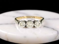 A three stone illusion-set diamond ring, size M CONDITION REPORT: Marks rubbed. 1.