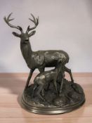 A bronzed resin figure group of a stag and fawn, height 33 cm.