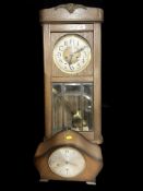 An early 20th century oak cased wall clock and a Smiths mantel clock.