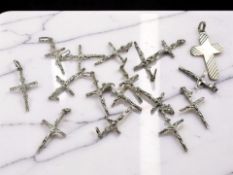 A group of sterling silver crucifix pendants. CONDITION REPORT: 34g.