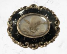 A Victorian enamelled mourning brooch backed in yellow metal