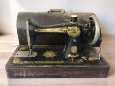A Singer hand sewing machine, in case.