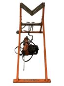 A Black & Decker electric chainsaw and a saw horse.