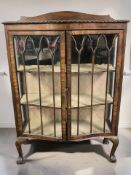A 1920's mahogany serpentine-fronted display cabinet, width 90 cm.