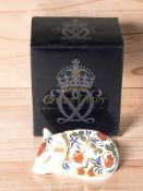 A Royal Crown Derby sleeping piglet paperweight with gold stopper, with original box.