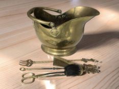 A Victorian brass coal helmet and companion pieces.