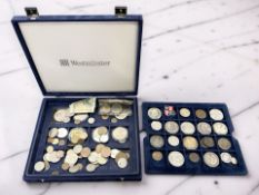 A case containing assorted coins including five £5 coins, crowns, other assorted pre-decimal,