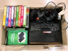 An Atari video computer system, with controllers, leads, various games.