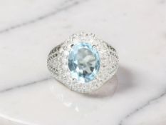 A cluster ring set with natural 3ct blue topaz and cubic zirconia,