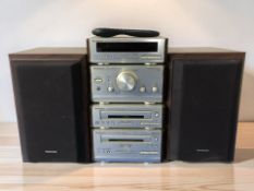 A Technics micro hi-fi system with a pair of speakers and remote.