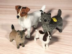 A Beswick jack russell terrier, length 16 cm, two further Beswick dogs and a Goebel dog.