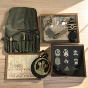 A group of cap badges, military photographs, a Swiss Army type knife, compass, lighter, etc.