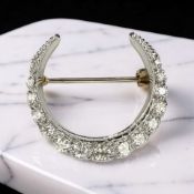A 9ct gold diamond crescent brooch, width 2.