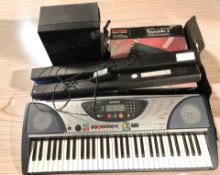 A Yamaha PSR-240 digital keyboard, a Samsung speaker, Samsung soundbar,