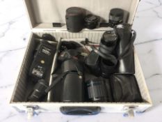 An aluminium camera case containing a Halina AF Sensor camera and various lenses including Hanimex,