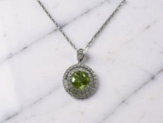 A silver pendant set with natural 3ct peridot on white metal chain,